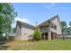 View of the backyard showing the deck, brick foundation, and green lawn at 48 Arlington Dr, Cameron, NC 28326