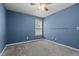 Carpeted bedroom with blue walls, a window, and a ceiling fan, providing a serene atmosphere at 48 Arlington Dr, Cameron, NC 28326