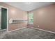 Bedroom with neutral walls, carpet, and natural light from a window, and custom built-in shelving at 48 Arlington Dr, Cameron, NC 28326