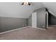 Attic bedroom with a ceiling fan, carpet flooring, and a door, offering a cozy space at 48 Arlington Dr, Cameron, NC 28326