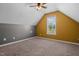 Attic bedroom with a window providing ample natural light and a ceiling fan for climate control at 48 Arlington Dr, Cameron, NC 28326