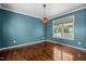 Bright dining room with hardwood floors, decorative lighting, and large window at 48 Arlington Dr, Cameron, NC 28326