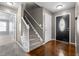 The home features a welcoming entryway with stairs to the second level and attractive hard wood flooring at 48 Arlington Dr, Cameron, NC 28326