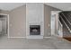 Cozy living room with a beautiful stone fireplace, stairs to second level, and carpeted floors at 48 Arlington Dr, Cameron, NC 28326