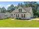 Well-manicured front lawn, brick facade, vinyl siding, and a two-car garage at 48 Arlington Dr, Cameron, NC 28326