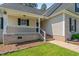 The home features a cozy front porch with brick accents and well-manicured landscaping creating a welcoming entrance at 48 Arlington Dr, Cameron, NC 28326