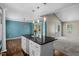 Open kitchen features an island, white cabinets, stainless appliances and opens to the dining and living room at 48 Arlington Dr, Cameron, NC 28326
