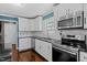 Bright kitchen featuring white cabinets, granite countertops, stainless appliances, and a decorative backsplash at 48 Arlington Dr, Cameron, NC 28326