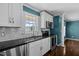 Updated kitchen featuring white cabinets, granite countertops, stainless appliances and a decorative backsplash at 48 Arlington Dr, Cameron, NC 28326