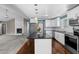 Open kitchen featuring white cabinets, granite countertops, stainless appliances, and a large island at 48 Arlington Dr, Cameron, NC 28326