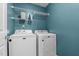 Bright laundry room features Maytag washer and dryer, storage shelf, and a clean, functional space at 48 Arlington Dr, Cameron, NC 28326