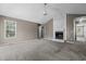 A spacious living room with fireplace and large windows, perfect for gatherings and creating lasting memories at 48 Arlington Dr, Cameron, NC 28326