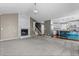 This living room showcases a cozy fireplace, carpeted floors and stairs to second level that create a inviting atmosphere at 48 Arlington Dr, Cameron, NC 28326