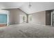 A large living room features vaulted ceilings, plush carpet and glass patio doors for ample natural light at 48 Arlington Dr, Cameron, NC 28326