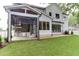 Backyard view of the home's screened porch with outdoor kitchen and an expansive lawn at 4921 Sweetbriar Dr, Raleigh, NC 27609