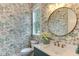 Stylish powder room with patterned wallpaper, round mirror, and a modern vanity with sink at 4921 Sweetbriar Dr, Raleigh, NC 27609