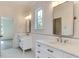Bright bathroom with dual sink vanity, white cabinets, marble countertop, and tiled floor and walls at 4921 Sweetbriar Dr, Raleigh, NC 27609