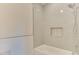 Bathroom with gray subway tile, shower head, built-in niche, and white bathtub at 4921 Sweetbriar Dr, Raleigh, NC 27609
