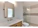 Modern bathroom featuring marble countertops, a glass-enclosed shower, and stylish fixtures for a luxurious spa experience at 4921 Sweetbriar Dr, Raleigh, NC 27609