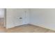 Bright bedroom with hardwood floors and double doors leading to a walk-in closet at 4921 Sweetbriar Dr, Raleigh, NC 27609