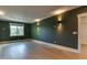 Spacious bedroom with hardwood flooring, modern lighting fixtures, and large windows with backyard views at 4921 Sweetbriar Dr, Raleigh, NC 27609