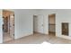 Bright bedroom with hardwood flooring featuring several doors offering access to closet space and other rooms at 4921 Sweetbriar Dr, Raleigh, NC 27609