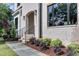 A close-up of a bright brick house with steps, dark windows, and landscaping at 4921 Sweetbriar Dr, Raleigh, NC 27609