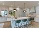 Modern kitchen features a spacious island with seating, stainless steel appliances, and a white marble countertop at 4921 Sweetbriar Dr, Raleigh, NC 27609