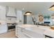 Modern kitchen with white cabinets, a farmhouse sink, and stainless-steel appliances at 4921 Sweetbriar Dr, Raleigh, NC 27609