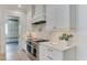 Contemporary kitchen design features a stainless steel range, marble countertops, and custom white cabinetry at 4921 Sweetbriar Dr, Raleigh, NC 27609