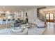 Open-concept living space with hardwood floors, a modern staircase, and lots of natural light at 4921 Sweetbriar Dr, Raleigh, NC 27609