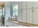 Mudroom with built-in bench, custom cabinets for storage, and a view to the exterior at 4921 Sweetbriar Dr, Raleigh, NC 27609