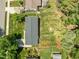 Aerial view of a home featuring a large backyard, mature trees, and a firepit at 5208 Melbourne Rd, Raleigh, NC 27606