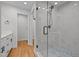 Updated bathroom features marble-like tiles and updated fixtures at 5208 Melbourne Rd, Raleigh, NC 27606