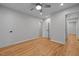 Spacious bedroom with hardwood floors, ceiling fan, recessed lighting, and ample closet space at 5208 Melbourne Rd, Raleigh, NC 27606