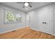 Cozy bedroom featuring hardwood floors, natural light, a ceiling fan, and closet at 5208 Melbourne Rd, Raleigh, NC 27606
