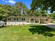 Charming home featuring a well-maintained lawn, brick facade, covered entryway, and a convenient carport at 5208 Melbourne Rd, Raleigh, NC 27606
