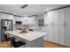 Bright kitchen featuring white cabinetry, stainless steel appliances, and an island with bar seating at 5208 Melbourne Rd, Raleigh, NC 27606