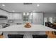 Spacious kitchen with a large center island, white cabinets, and modern pendant lighting at 5208 Melbourne Rd, Raleigh, NC 27606