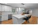Elegant kitchen with a center island, modern appliances, and a view to the dining area at 5208 Melbourne Rd, Raleigh, NC 27606