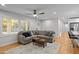 Cozy living room featuring a sectional sofa, natural light, and hardwood flooring at 5208 Melbourne Rd, Raleigh, NC 27606