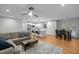Bright and airy living room with comfortable seating, hardwood floors, and a view to the kitchen at 5208 Melbourne Rd, Raleigh, NC 27606
