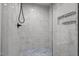 Updated shower features marble-like tiles, a glass door, and updated fixtures at 5208 Melbourne Rd, Raleigh, NC 27606