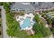 Aerial shot of luxury community pool, landscaping, and the exterior of the clubhouse at 524 Clarenbridge Dr, Cary, NC 27519