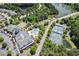A beautiful aerial view of the community pool, tennis courts, and lush landscaping near a scenic lake at 524 Clarenbridge Dr, Cary, NC 27519