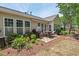 Backyard features a grill, table, and awning-covered patio. The yard is landscaped with flowerbeds at 524 Clarenbridge Dr, Cary, NC 27519