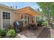 Backyard features a grill, table, and awning-covered patio next to flowerbeds and well-manicured lawn at 524 Clarenbridge Dr, Cary, NC 27519