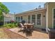 Tiled patio with dining set, grill, and awning offers a relaxing outdoor space with lush landscaping at 524 Clarenbridge Dr, Cary, NC 27519