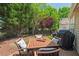 Private backyard retreat with a table and chairs set on a tiled patio perfect for outdoor dining at 524 Clarenbridge Dr, Cary, NC 27519