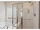 Bright bathroom featuring a soaking tub and glass enclosed shower with a window with privacy glass at 524 Clarenbridge Dr, Cary, NC 27519